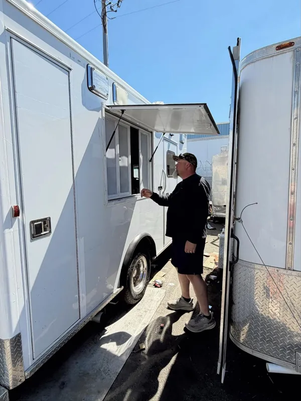 The service window propped open on the side of the truck